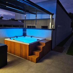 a jacuzzi tub on a house with aperature at Beautiful Cozy Beach House Accommodation in Guaratuba