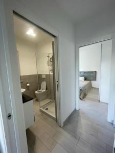 a room with a bathroom with a toilet and a mirror at Casa Mare Sabaudia in Sabaudia +17 photos