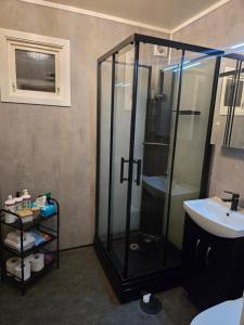 a bathroom with a shower and a sink at Takelvdal in Björklid