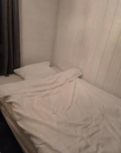 an unmade bed with white sheets in a room at Takelvdal in Björklid +3 photos