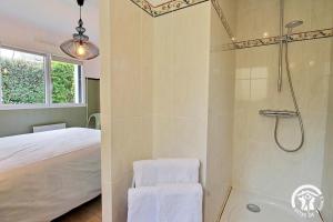 a bathroom with a shower and a bed at La maison de chris in Theix +42 photos