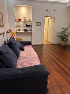 a living room with a couch and a wooden floor at Copacabana Rooms & Hostel in Rio de Janeiro