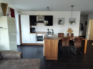 a kitchen and dining room with a table and chairs at Nordsee Resort in Wangerland