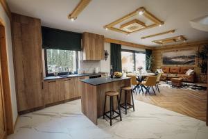 a kitchen and living room with a table and chairs at Krzeptówki House in Zakopane