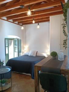 a bedroom with a bed and a table and lights at Corredera Travel 5 in Córdoba