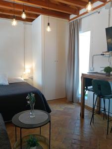 a bedroom with a bed and a table and a desk at Corredera Travel 5 in Córdoba