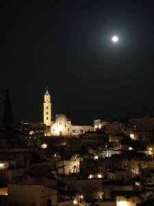 a view of a city at night with the moon at Klimt-Van Gogh-Dolci Impressioni in Matera