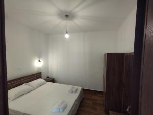 a bedroom with a bed with two towels on it at Αίγλη Apartment in Ierissos