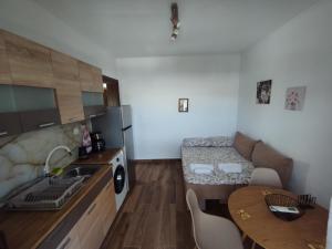 a small kitchen with a sink and a table at Αίγλη Apartment in Ierissos