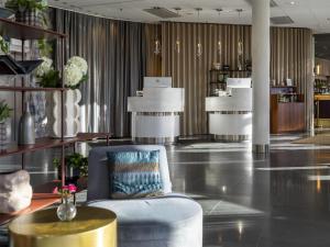 a lobby with a chair and a table in a store at Radisson Blu Hotel Uppsala in Uppsala