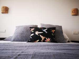 a bed with a black pillow with birds on it at s'Herència in Porreres