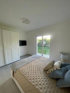 a bedroom with a large bed and a large window at Casa Mare Sabaudia in Sabaudia