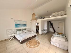 a living room with a bed and a couch at Aura Mar in Ponta do Ouro +21 photos