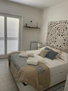 a bedroom with a large bed with pillows on it at Casa Mare Sabaudia in Sabaudia