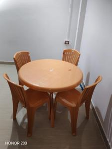 a wooden table with four chairs around it at Jinkos Homestay with self cooking facility in Itānagar