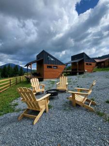 a group of chairs sitting in front of a building at Nord Hill in Poiana Negrii