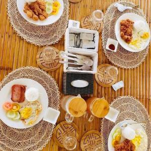 a table with plates of breakfast foods and drinks at Marinelli Beach Resort in San Agustin