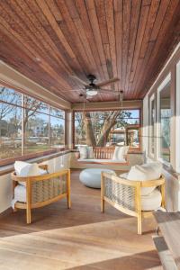 a living room with chairs and a ceiling fan at Featherstone in White Bear Lake