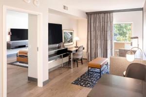 a hotel room with a living area with a television at Grand Canyon Railway Hotel in Williams