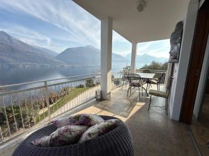 a balcony with a view of a lake and mountains at White House in Cremia +14 photos
