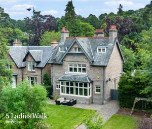 an exterior view of a large brick house at St Giles Lodge in Inverness