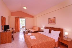 a hotel room with a bed and a living room at Νηρηίδες Apartments Studios in Kyparissia +81 photos