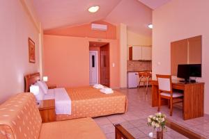 a hotel room with a bed and a living room at Νηρηίδες Apartments Studios in Kyparissia