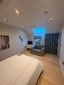 a bedroom with a large bed and a couch at The stables at the Grange in York