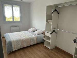 a bedroom with a bed and a book shelf at Les camins in Hirel