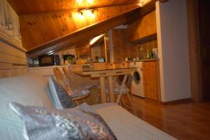a kitchen with a couch and a sink in a room at Il Nido in Valdisotto +19 photos