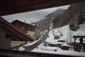 a view from a window of a snow covered mountain at Il Nido in Valdisotto