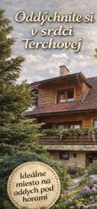 a sign in front of a house with a building at Penzion pod Brehom in Terchová