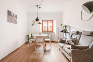 a living room with a table and a couch at Casa GAH Ripatransone Suite nel Borgo tra Mare e Calanchi in Ripatransone