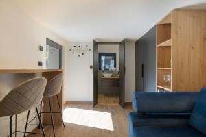 a living room with a blue couch and chairs at Chata 01 in Čeladná
