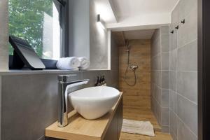 a bathroom with a white bowl sink on a wooden counter at Chata 01 in Čeladná +14 photos