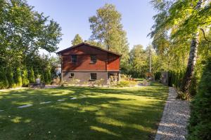 a house in the middle of a grassy yard at Chata 01 in Čeladná