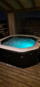 a large hot tub with blue water in a room at Scandidim Lutsk in Lutsk