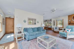 a living room with a blue couch and chairs at 3660 - Duckingham in Duck