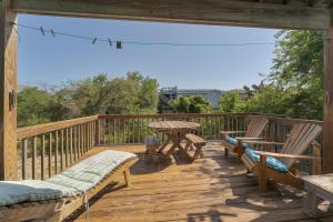 a wooden deck with two chairs and a table on it at 3660 - Duckingham in Duck +13 photos