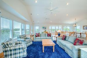a living room with couches and chairs and a table at 3215 - Papa Duck in Duck