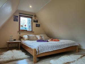 a bedroom with a bed in a attic at Kraina Szczęśliwości in Zawoja
