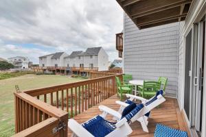 a deck with chairs and tables on a house at 4209 - Moby Duck in Duck