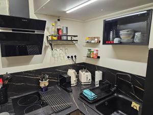 a kitchen with a black counter top with a sink at studio classé 3 étoiles, Anglet Chiberta ocean golf surf in Anglet