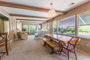 a dining room with a wooden table and chairs at 4601 - Sandy Bluff in Southern Shores +16 photos