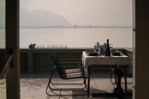 a table and chairs with a view of the water at CASA Virginia - DEEP BLUE in Predore