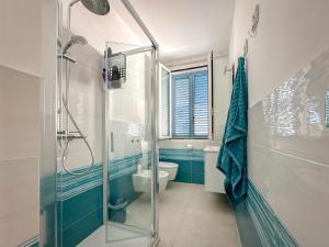 a bathroom with a glass shower and a toilet at Casa Ammos in Platamona +17 photos