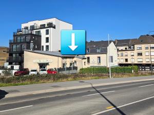 a sign on the side of a road next to a building at Lisboa II Hotel Restaurant in Luxembourg