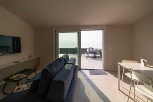 a living room with a couch and a table with a view at CASA Virginia - DEEP BLUE in Predore