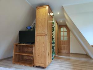 a staircase with a door and a television in a room at Kraina Szczęśliwości in Zawoja