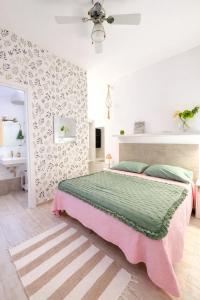 a bedroom with a large bed and a bathroom at Villa Volli Three Rooms in Agrigento